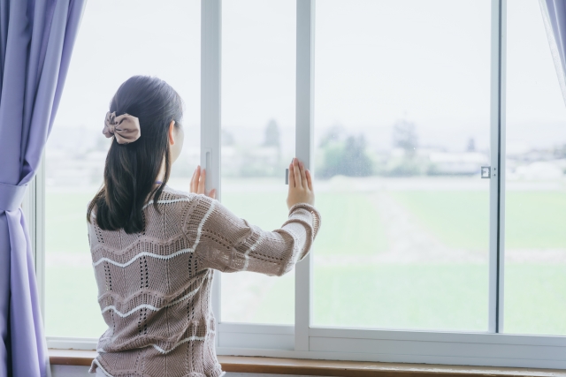 部屋の換気をする女性